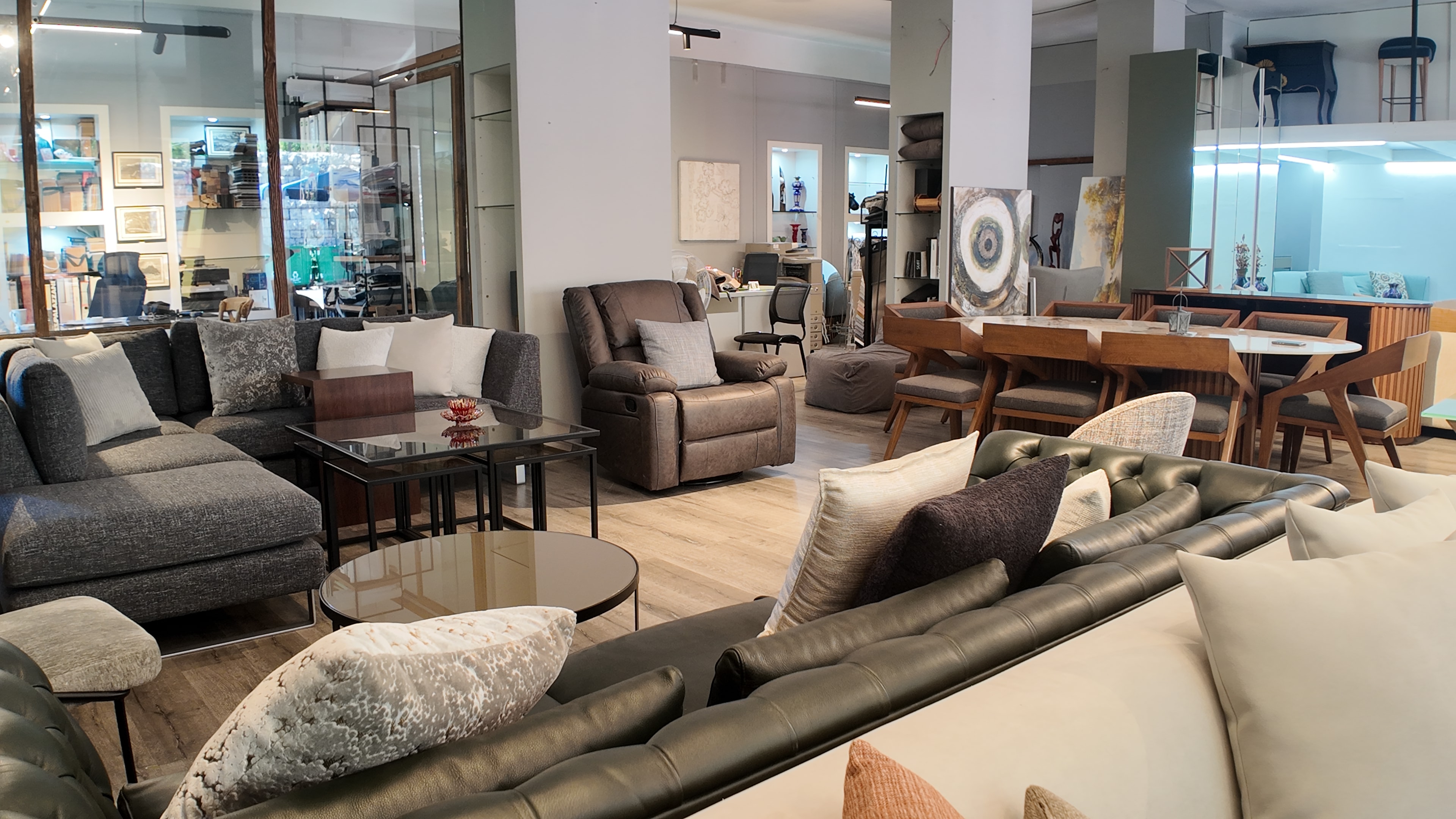 Inside the Gallery LA showroom in Baabdet — sofas, recliners, dining, and art on the floor
